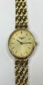 LONGINES 18CT GOLD LADIES' BRACELET WATCH with oval case, champagne dial, baton hour markers,