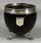 GEORGIAN COCONUT CUP having silver mounted rim, shield cartouche and hoof and shell feet, circa