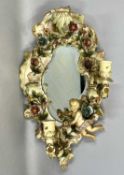 GERMAN PORCELAIN FRAMED WALL MIRROR, encrusted with flowers, with cherub and three candle sconces,