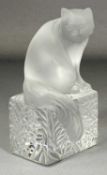 LALIQUE 'DOUMI' FROSTED GLASS CAT PAPERWEIGHT, seated on patterned square base, etched signature '