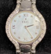 EBEL LADIES' WRISTWATCH, circular case with diamond set bezel, mother of pearl dial with diamond and