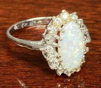 9CT WHITE GOLD OPAL RING, central oval stone surrounded by small diamonds, size N, 2.2gms