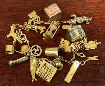9CT GOLD CHARM BRACELET with approx. 20 gold charms and others, 42.3gms gross Provenance: private