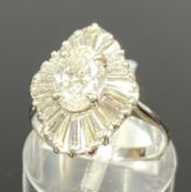 WHITE GOLD DIAMOND BALLERINA RING, oval principal stone within tiered tapered baguette cut diamond