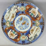 LARGE 19TH CENTURY JAPANESE IMARI CIRCULAR CHARGER having central panel painted with flowers,