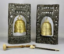 TWO CHINESE BUDDHIST TEMPLE BELLS decorated with dragons and supported within carved hardwood