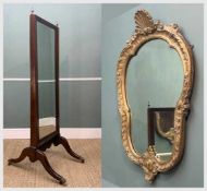 TWO MIRRORS comprising mahogany cheval mirror, brass finials, brass lions paw feet, brass castors,