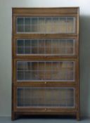 EARLY 20TH C. OAK SECTIONAL BOOKCASE BY ANGUS, four tiers, leaded glazed up-and-over front panels,