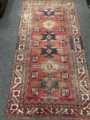VINTAGE KARADJA NARROW RUG, Persia, six hooked medallions on a madder field interspersed with