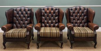 THREE LEATHER VICTORIAN-STYLE WING BACK ARMCHAIRS, brown button-back upholstery, loose striped cloth