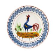 LLANELLY POTTERY COCKEREL PLATE circa 1900, naively painted with a standing cockerel and plants,