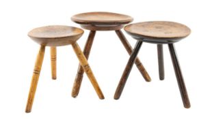 THREE TURNED MILKING STOOLS, with cheese tops, each on three legs, largest 34cms h (3) Provenance: