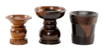 THREE TURNED TREEN POUNCE POTS, two in lignum vitae and another in fruitwood, largest 9cms h (3)