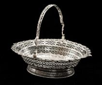 GEORGE III SILVER SWING HANDLED BASKET by William Plummer, London c. 1775, finely pierced with three