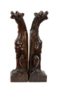 PAIR OF CARVED OAK MYTHOLOGICAL BEASTS, possibly architectural fittings, in the form of wyverns,