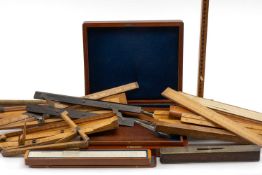 ASSORTED MEASURING TREEN including foot measures, slide rules, brass and mahogany spirit level,