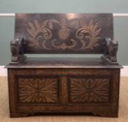 ANTIQUE CARVED OAK MONKS BENCH, tilt action top carved with stylised Price of Wales feathers, carved