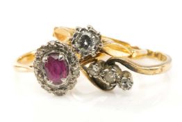 THREE 18CT GOLD & PLATINUM RINGS comprising ruby and diamond cluster ring, three stone diamond twist