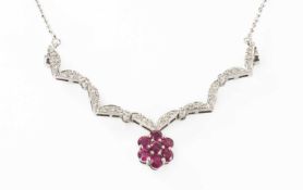 WHITE METAL DIAMOND & RUBY NECKLACE of flowerhead design, stamped '750', 6.4gms Provenance: