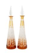 PAIR OF BACCARAT STYLE CONICAL TAPERING DECANTERS, clear with amber overlay, pyramid stopper,