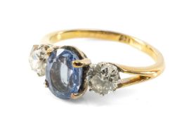 18CT GOLD THREE STONE SAPPHIRE & DIAMOND RING, the central oval sapphire (7 x 5mms) flanked by two