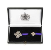 BOXED 'THE ELIZABETH CROSS' comprising two pin back sterling silver emblems, the cross decorated
