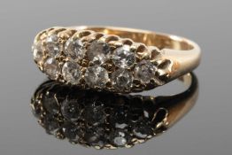 YELLOW METAL TEN STONE DIAMOND RING, set with two rows of old cut stones, ring size N, 4.4gms in