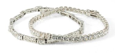 TWO 9CT WHITE GOLD LINE BRACELETS one of Greek key design, set with cubic zirconia stones, 18.0gms