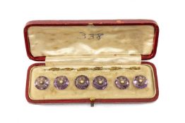 CASED SET OF AMETHYST & SEED PEARL BUTTONS, faceted circular with split pearl centres in yellow