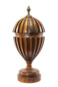MODERN REPRODUCTION GEORGIAN STYLE MAHOGANY URN & COVER with brass pineapple finial, 35cms (h)