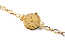 18CT GOLD LADIES' WRISTWATCH, the dial signed 'Harrods' with Arabic numerals, minute track and