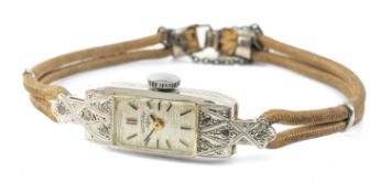 WHITE METAL ROTARY COCKTAIL WATCH set with diamonds, engraved inside 'Gold & Plat' Provenance: