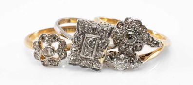 FOUR DIAMOND RINGS, comprising three 18ct gold examples (two flowerhead, one three stone) and a