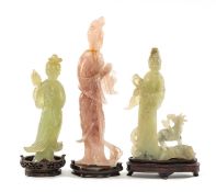 THREE CHINESE HARDSTONE CARVINGS OF IMMORTALS, one in rose quartz, other two in pale green stone/