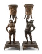PAIR JAPANESE BRONZE FIGURAL CENSERS, Meiji Era, modelled as Sumo wrestlers holding aloft tripod