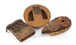 THREE AFRICAN MBIRA, one with gourd back, one with seed pod back, one of conventional wood form, the