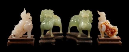 TWO PAIRS OF CHINESE HARDSTONE DOGS OF FO, one pair in pale green hardstone/bowenite, standing