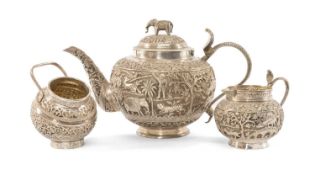 INDIAN WHITE METAL TEA SERVICE, comprising teapot, 24cms (l), sugar bowl and milk jug, all with