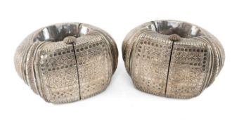PAIR 'ZANZIBAR ANKLETS', white metal with hinged pin fastenings, decorated with floral motifs within