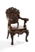 ANGLO-JAPANESE CARVED ARMCHAIR, Taisho/early Showa Era, profusely carved in high relief with three-