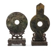 TWO CHINESE GREEN HARDSTONE ARCHAISTIC BI DISCS, one of conventional ring form, carved on one side