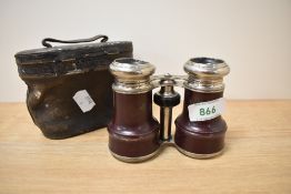 A pair of leather clad opera glasses with case.