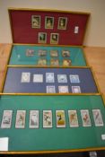 Four framed and glazed collections of stamps.