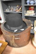 A vintage bowler hat 'The Owl Brand' sold with a late 19th/ early 20th century hat tin.