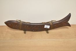 A carved softwood serving set in the form of a fish with brass mounts