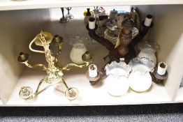A vintage brass ceiling light, having five arms and a carved oak ceiling light with four arms,