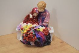 A Royal Doulton bone china figure group 'Flower Seller's Children' HN1342, designed by Leslie