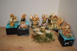 A collection of eleven Pendelfin hand-painted stoneware anthropomorphic rabbit figures and stands,