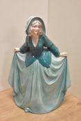 A German Art Deco Katzhutte Porcelain figurine, depicting gril in flowing green dress, printed
