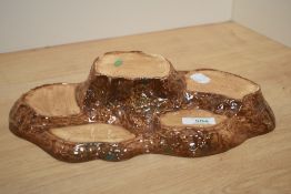 A Beswick Pottery Beatrix Potter gree stump-forkm display stand, of stepped arrangement, with